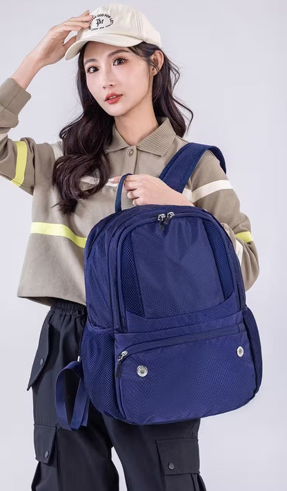 Woman wearing a blue backpack against a white background
