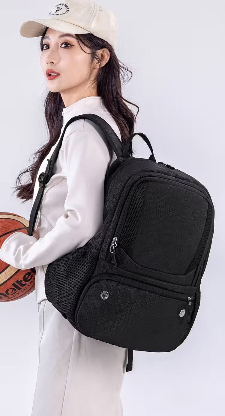 Person wearing a black backpack with a white background