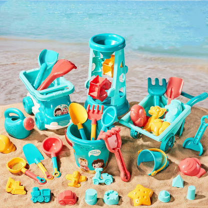 Collection of colorful beach toys on a sandy surface with a blurred beach background