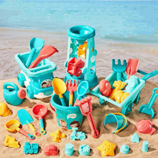 Collection of colorful beach toys on a sandy surface with a blurred beach background
