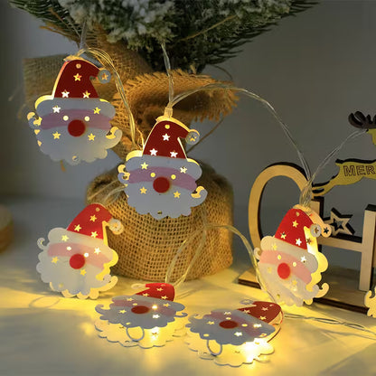 Decorative LED string lights shaped like cartoon characters with a Christmas theme, hanging on a tree.