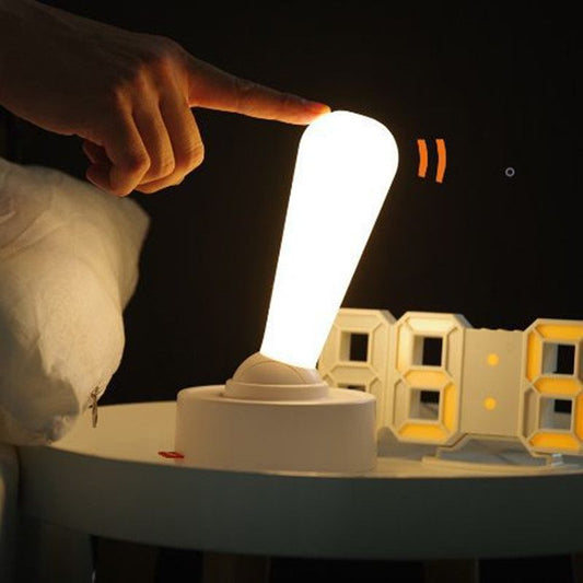 Person pointing at a glowing light bulb with numbers below on a dark background