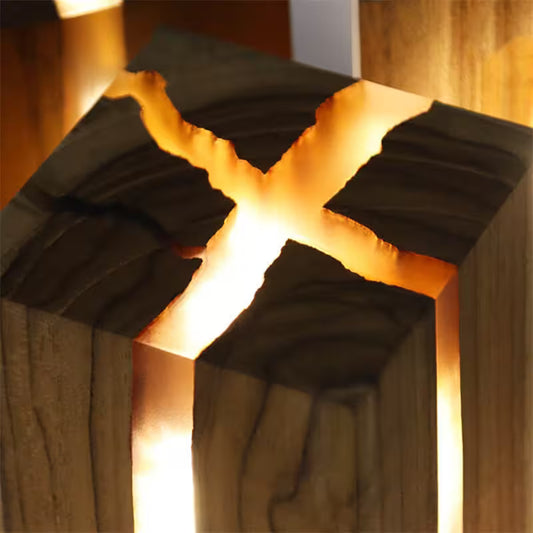 Wooden block with a glowing interior, resembling a cross.