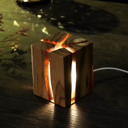 Wooden lamp with warm glow on a dark surface