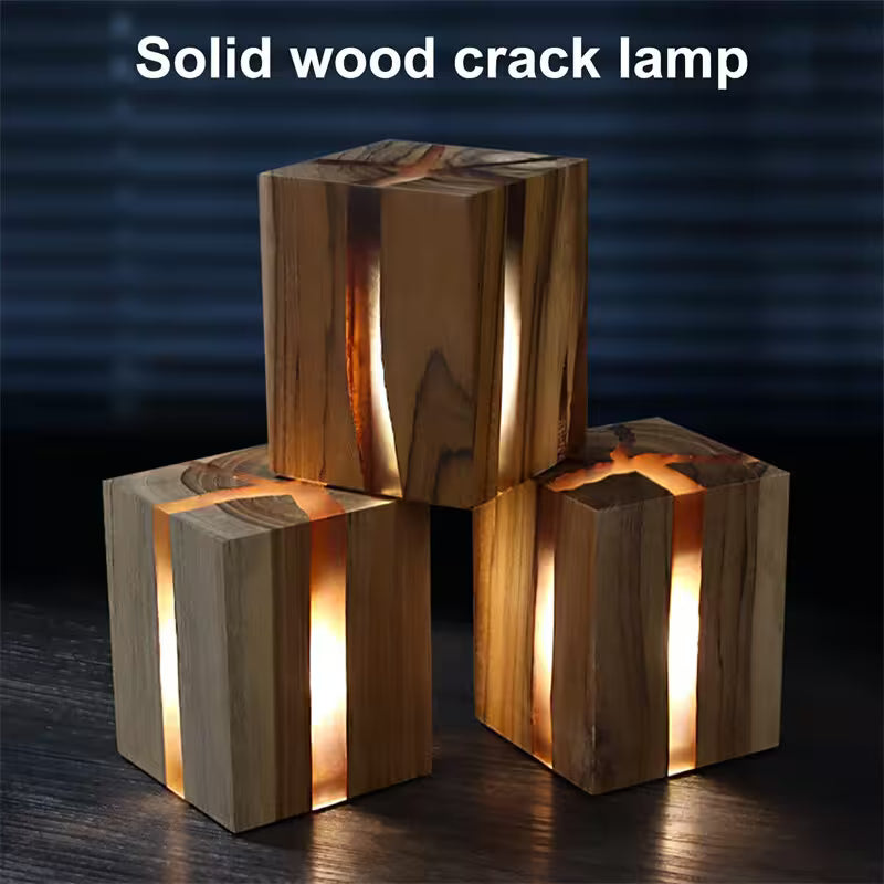 Three wooden lamp blocks with crack patterns on a dark background