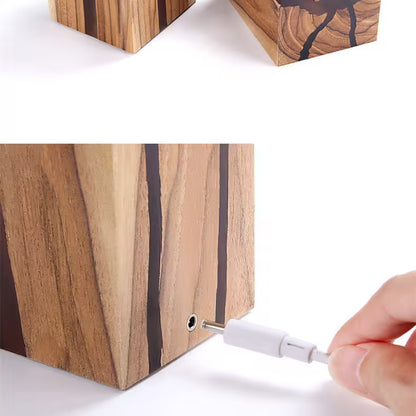 Wooden block with a screw being inserted into it, on a white background