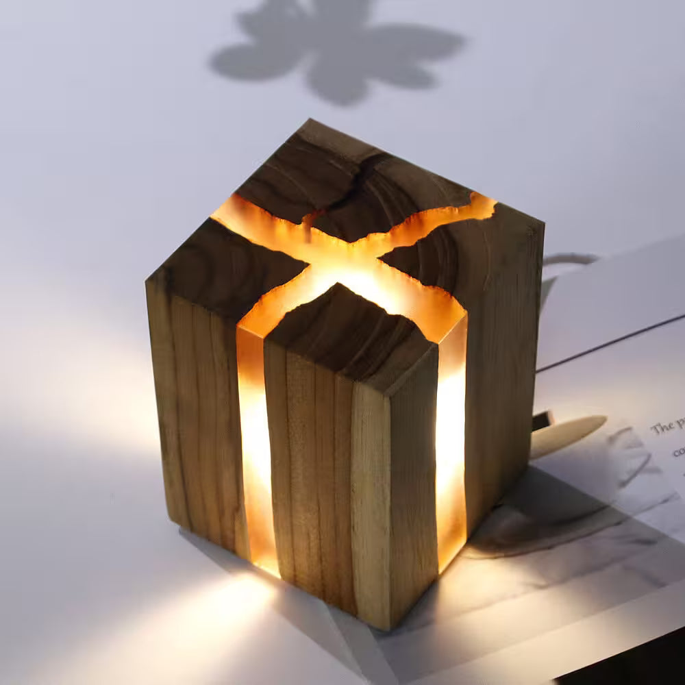 Wooden lantern with a warm glow on a white surface