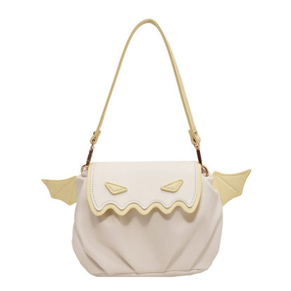 Beige handbag with gold accents on a white background