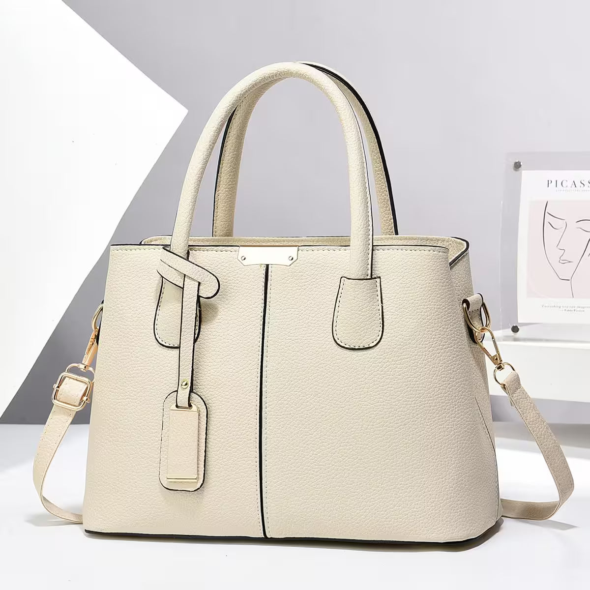 Beige handbag with a strap on a white background