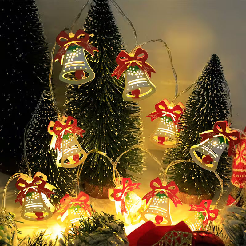 Decorative string lights with bell and bow designs on a Christmas tree background.
