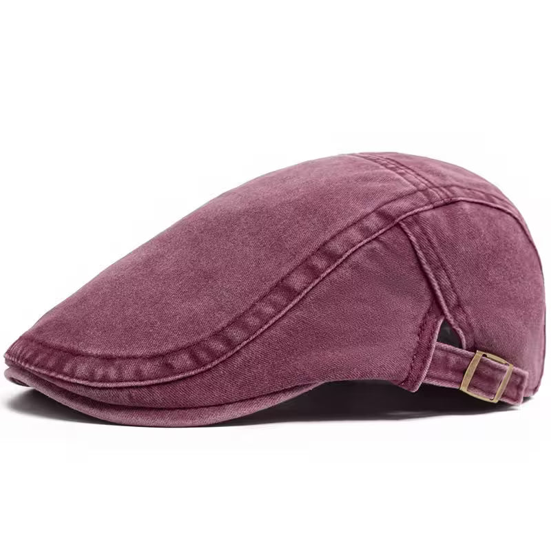 Purple flat cap with a gold buckle on a white background