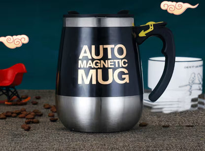 Black and silver 'Auto Magnetic Mug' with a red toy car and white mug in the background.
