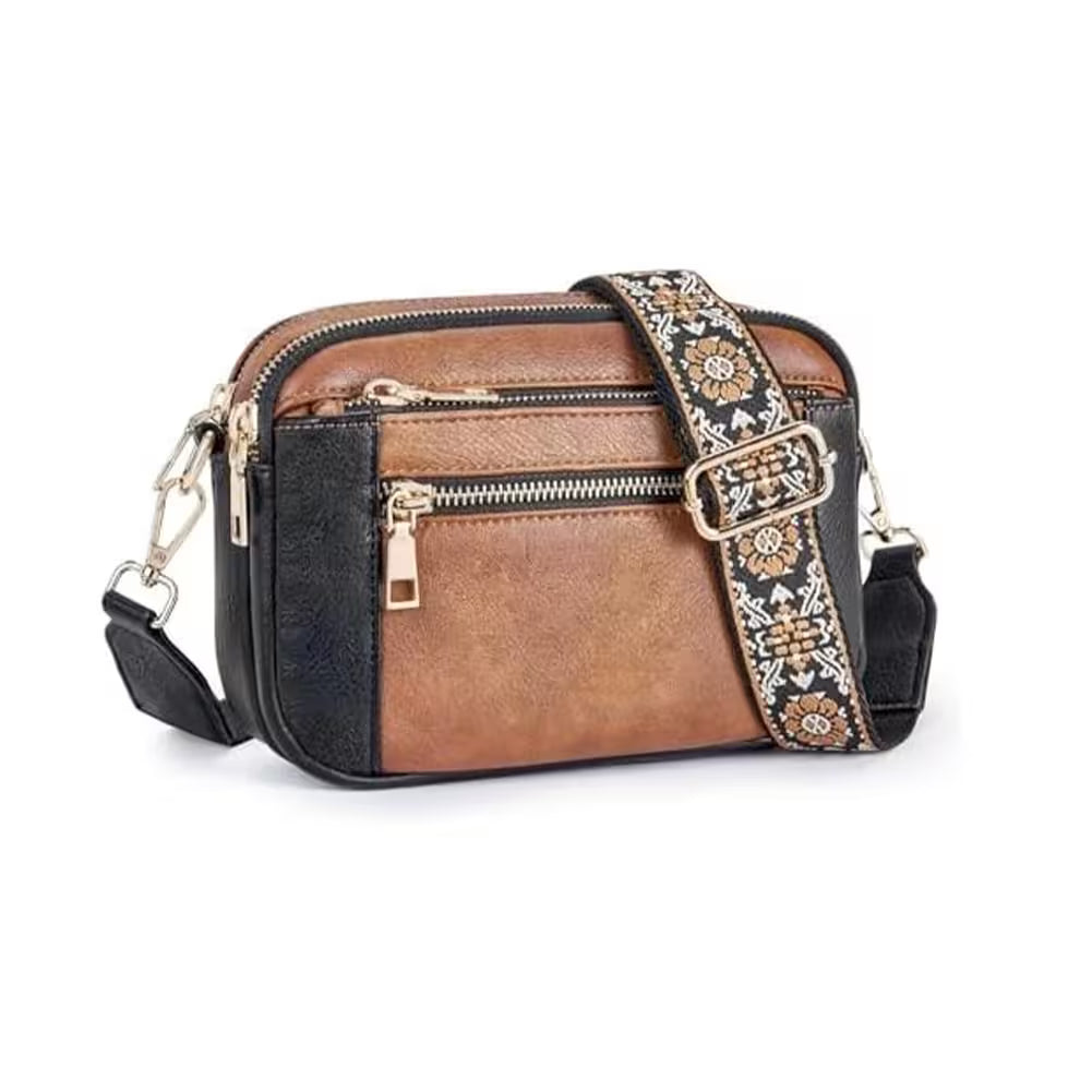 Brown and black crossbody bag with decorative strap on a white background