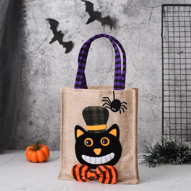 Halloween-themed jute bag with a black cat design against a gray textured background.