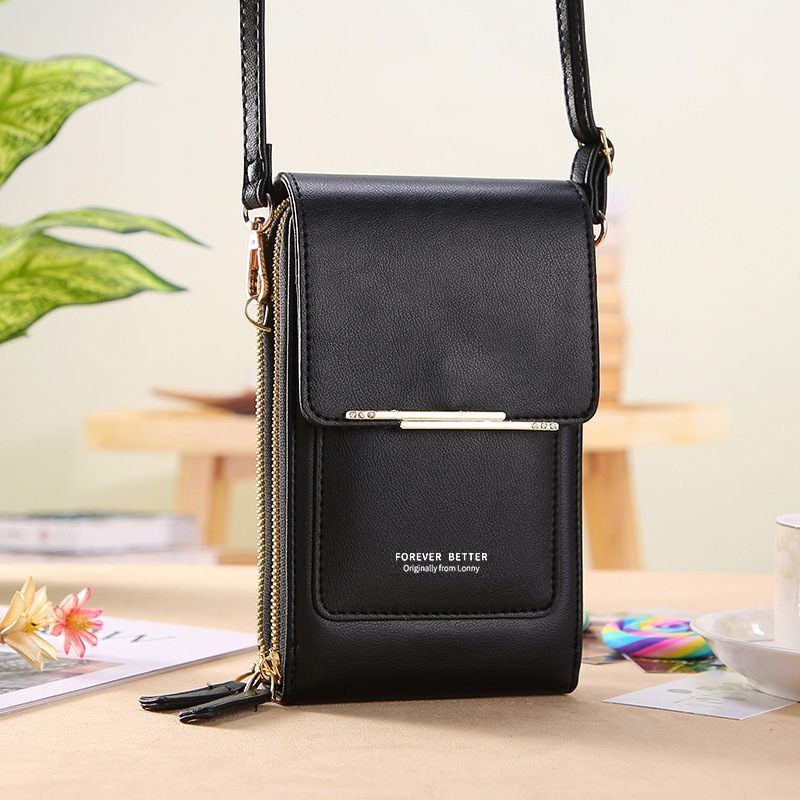 Black crossbody bag with a visible brand name on a blurred background
