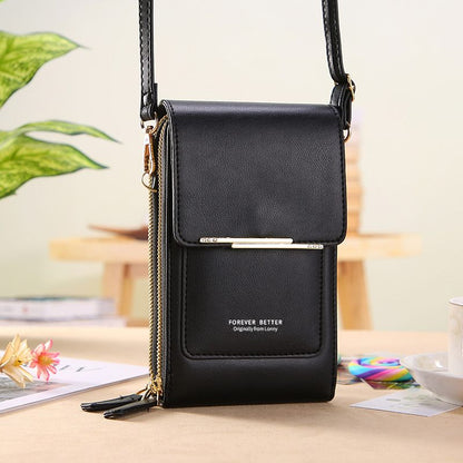 Black crossbody bag with a visible brand name on a blurred background
