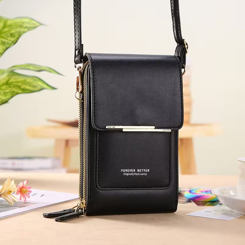Black crossbody bag with 'Forever Better' branding on a blurred indoor background
