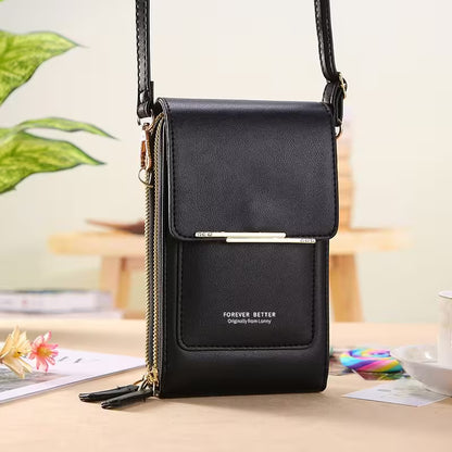 Black crossbody bag with 'Forever Better' branding on a blurred indoor background