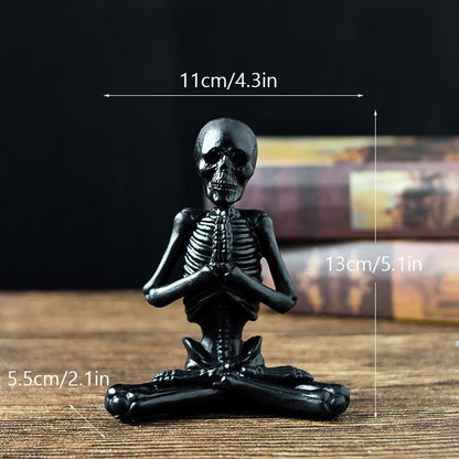 Black skeleton figurine on a wooden surface with measurements indicated