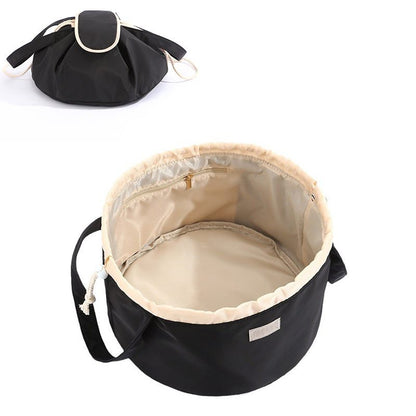 Black drawstring bag with beige interior on a white background