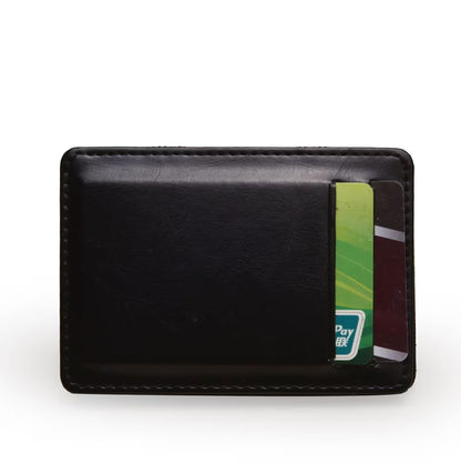Black leather cardholder with a few cards inside on a white background