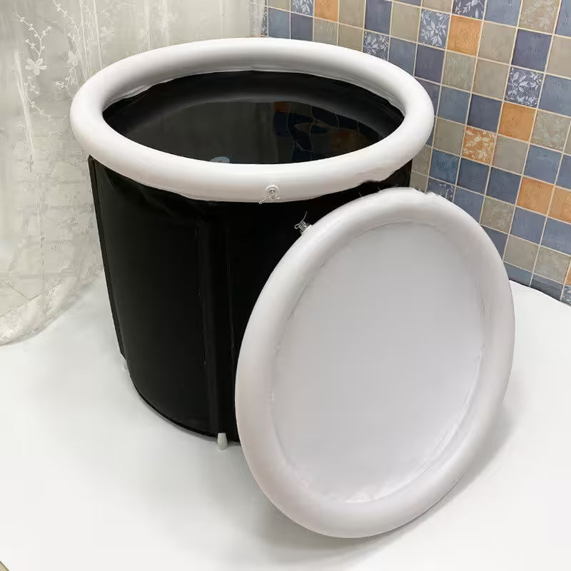 Black and white portable toilet with a lid on a tiled bathroom floor.
