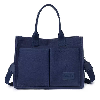 Navy blue tote bag with a shoulder strap on a white background
