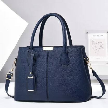 Blue handbag with gold accents on a white background