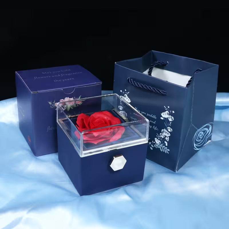 Blue gift box with a red rose inside on a white background