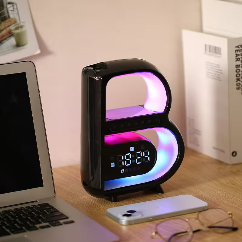 Letter 'B' shaped night light on a desk with laptop and phone