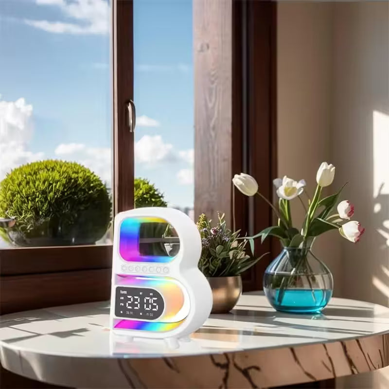 Colorful smart clock on a table with a window and plants in the background