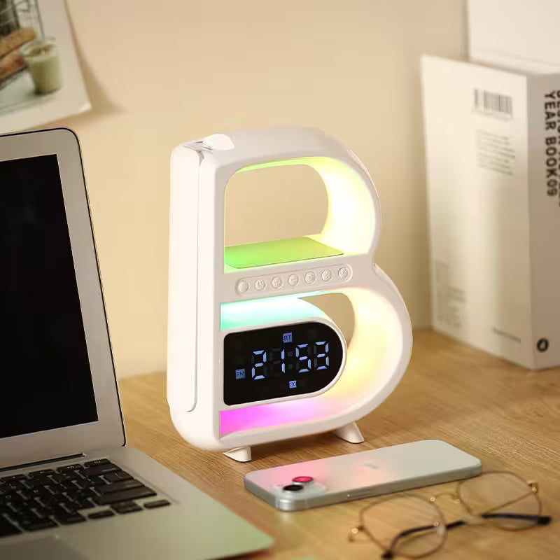 Multicolored LED lamp on a desk with laptop and phone