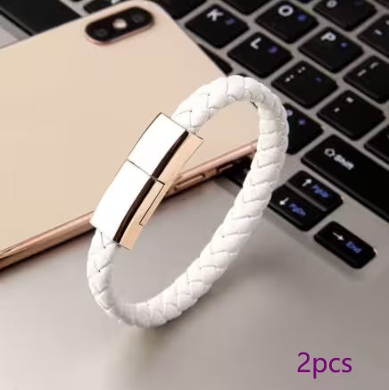 White braided USB drive with rose gold connector on a laptop keyboard