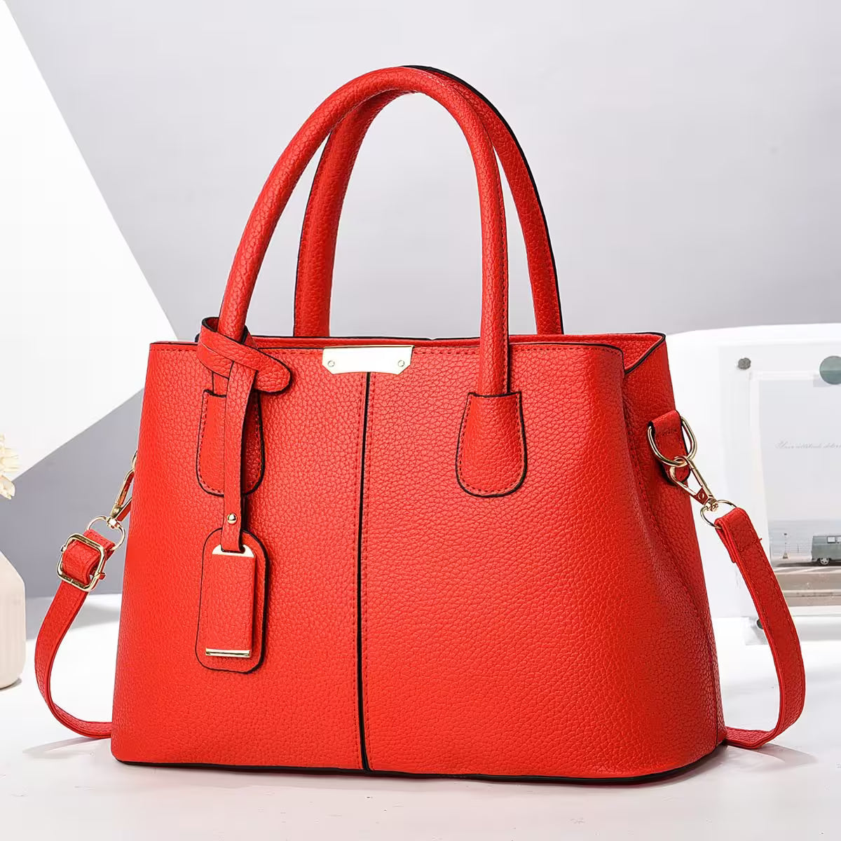 Red handbag with gold accents on a white background