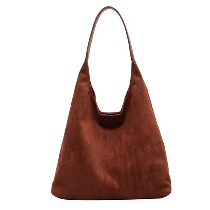 Brown suede handbag on a white background