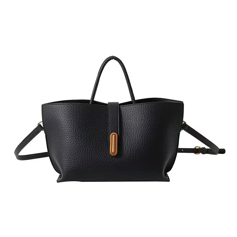 Black leather handbag with a brown buckle on a white background