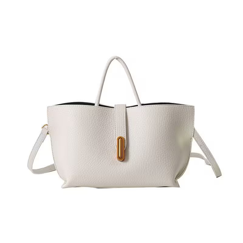 White handbag with a gold clasp on a white background