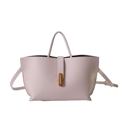 Light pink handbag with a gold clasp on a white background