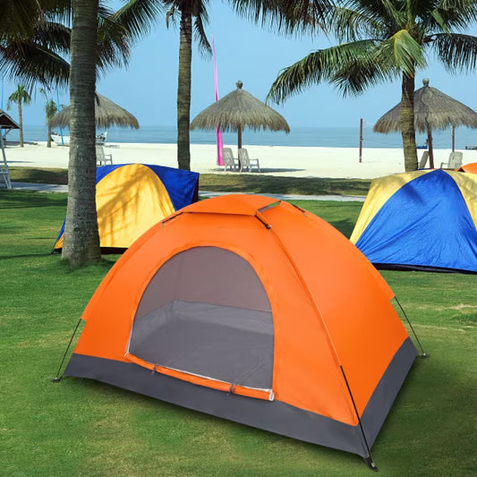 Orange tent with gray door on a grassy area with palm trees and beach in the background