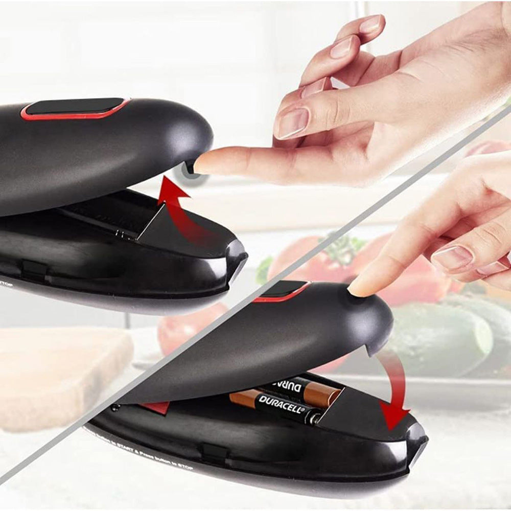 Black device with a red button being pressed, showing a close-up of a hand interacting with it.