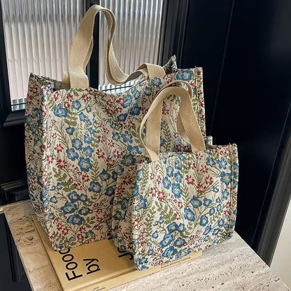 Floral-patterned tote bags on a surface with a dark background
