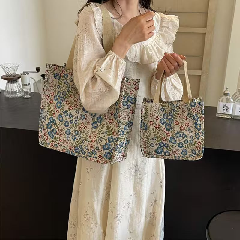 Person holding a floral tote bag in a kitchen setting