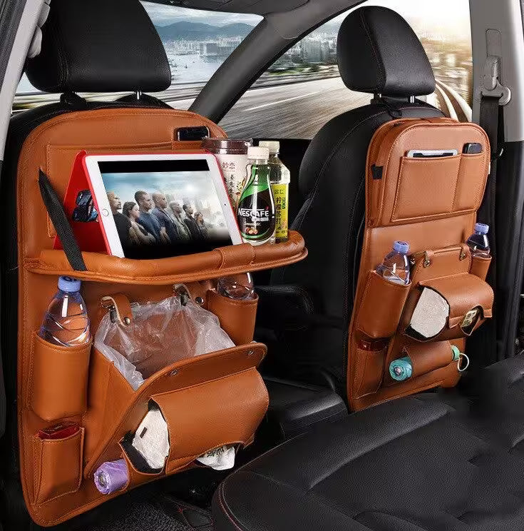 Car seat back organizers with multiple pockets and a tablet on a road trip.