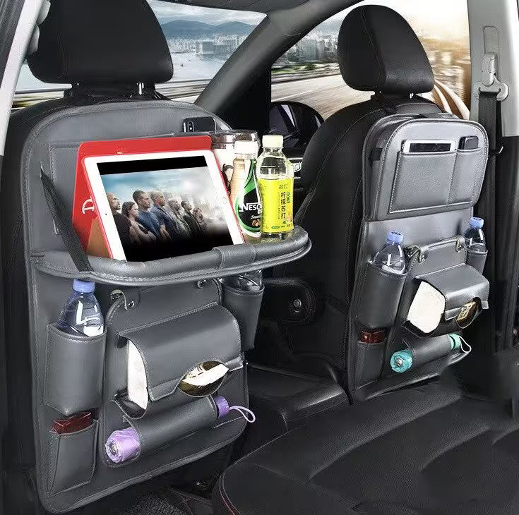 Car back seat organizer with tablet holder, drink holders, and snacks in a vehicle.