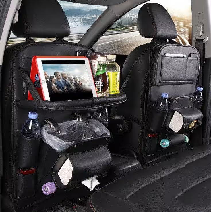 Car back seat with organizer, tablet, and drinks on a road trip.