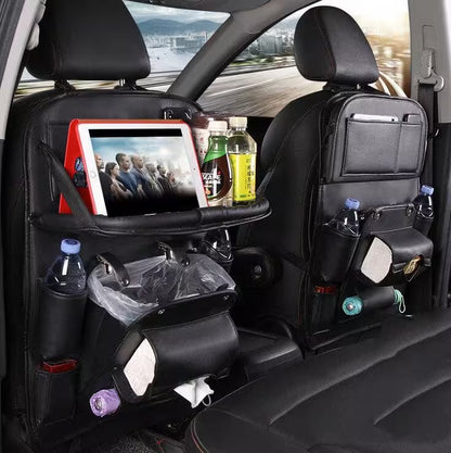 Car back seat with organizer, tablet, and drinks on a road trip.