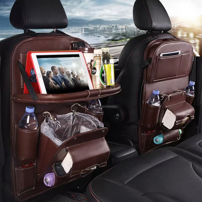 Car back seat organizer with multiple pockets and a tablet holder, filled with items.