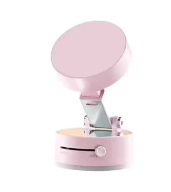 Pink phone holder with a round device on a white background