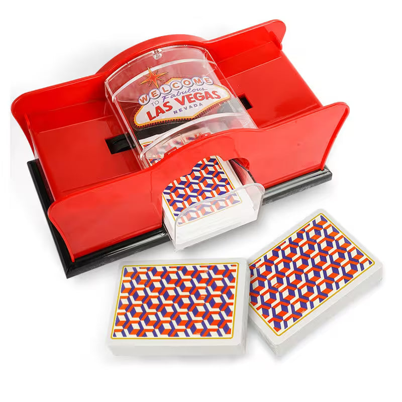 Playing card set with geometric design on a red card holder and 'Welcome to Fabulous Las Vegas' sign.