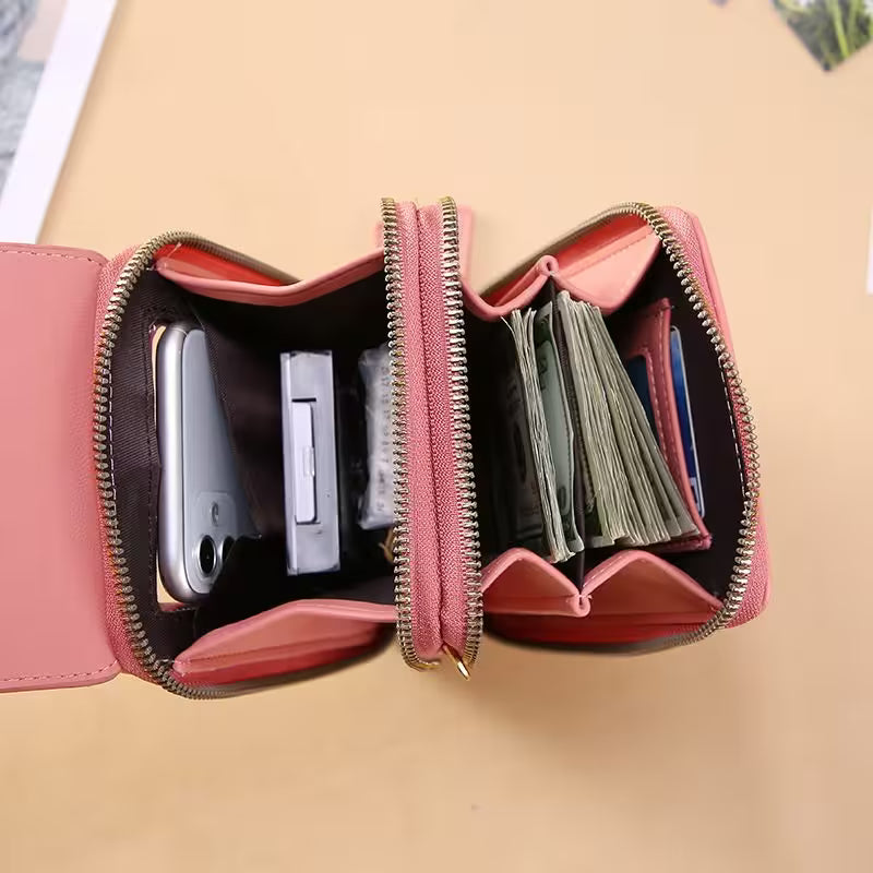 Pink wallet open to show its compartments on a beige background